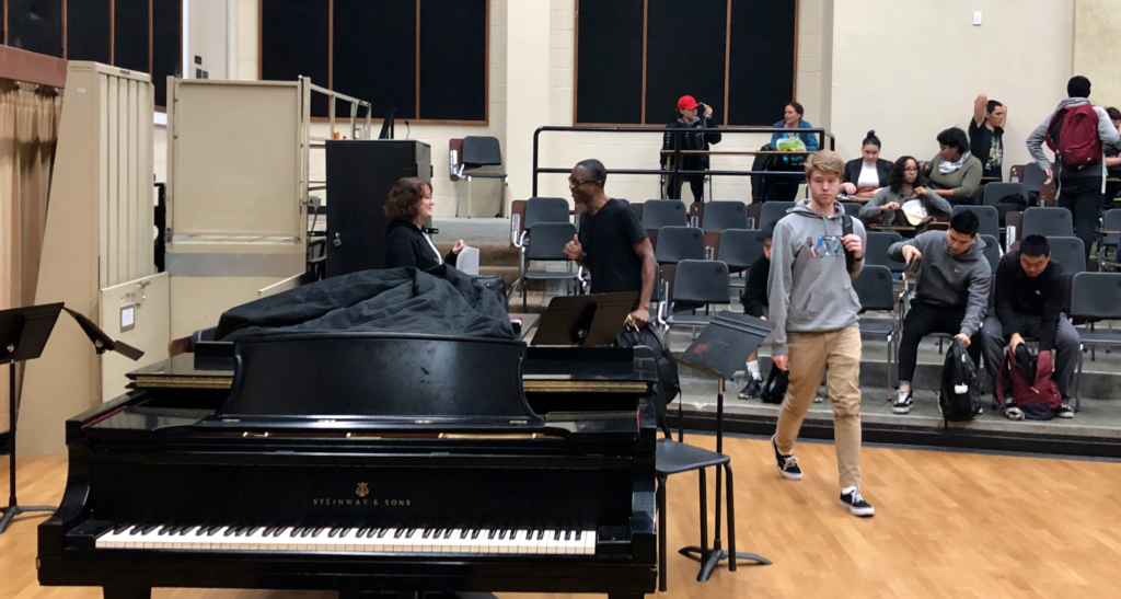 Professor Maya Ginsberg (far left) talks with one of her students after she dismissed her Music of Motown class on Dec. 11.